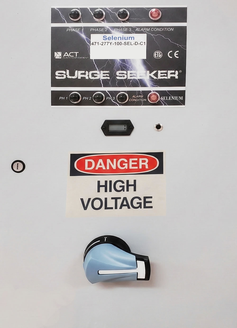 Danger high voltage warning on electrical surge panel with switches and controls.